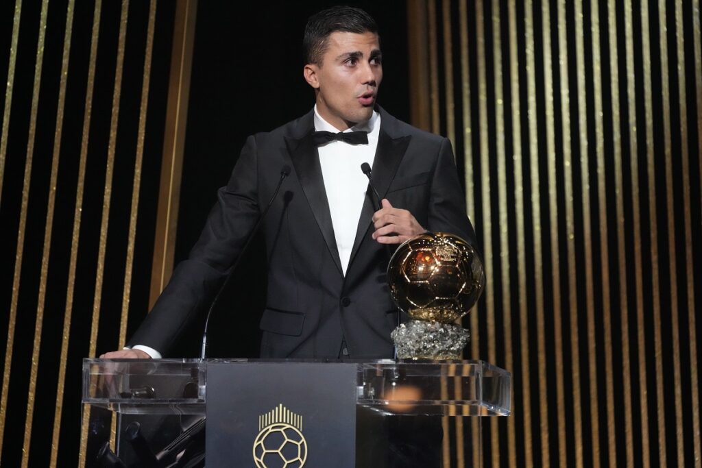 Manchester City's Spanish player Rodri delivers his speech as he receives the 2024 Men's Ballon d'Or award during the 68th Ballon d'Or (Golden Ball) award ceremony at Theatre du Chatelet in Paris, Monday, Oct. 28, 2024. (AP Photo/Michel Euler)