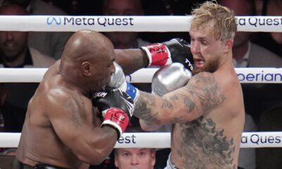 Mike Tyson hits Jake Paul during their heavyweight boxing match, Friday, Nov. 15, 2024, in Arlington, Texas. (AP Photo/Julio Cortez)