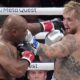 Mike Tyson hits Jake Paul during their heavyweight boxing match, Friday, Nov. 15, 2024, in Arlington, Texas. (AP Photo/Julio Cortez)