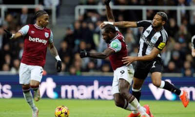 West Ham United's Michail Antonio, center, and Newcastle United's Joelinton, right, challenge for the ball during the English Premier League soccer match between Newcastle United and West Ham United in Newcastle, England, Monday, Nov. 25, 2024. (Richard Sellers/PA via AP)