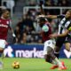 West Ham United's Michail Antonio, center, and Newcastle United's Joelinton, right, challenge for the ball during the English Premier League soccer match between Newcastle United and West Ham United in Newcastle, England, Monday, Nov. 25, 2024. (Richard Sellers/PA via AP)