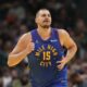 Denver Nuggets center Nikola Jokic smiles after making a basket against the Dallas Mavericks during the first half of an Emirates NBA Cup basketball game Friday, Nov. 22, 2024, in Denver. (AP Photo/Jack Dempsey)