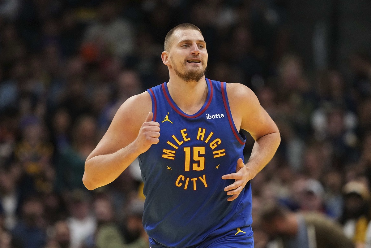 Denver Nuggets center Nikola Jokic smiles after making a basket against the Dallas Mavericks during the first half of an Emirates NBA Cup basketball game Friday, Nov. 22, 2024, in Denver. (AP Photo/Jack Dempsey)