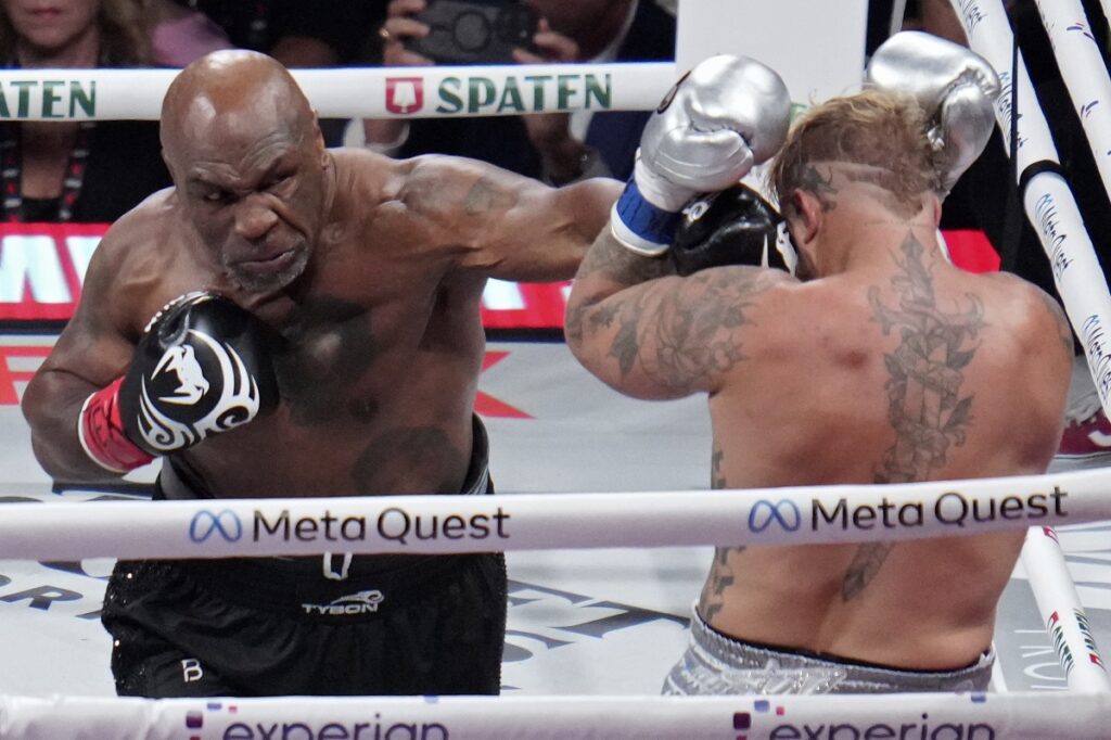 Mike Tyson lands a left to Jake Paul during their heavyweight boxing match, Friday, Nov. 15, 2024, in Arlington, Texas. (AP Photo/Julio Cortez)