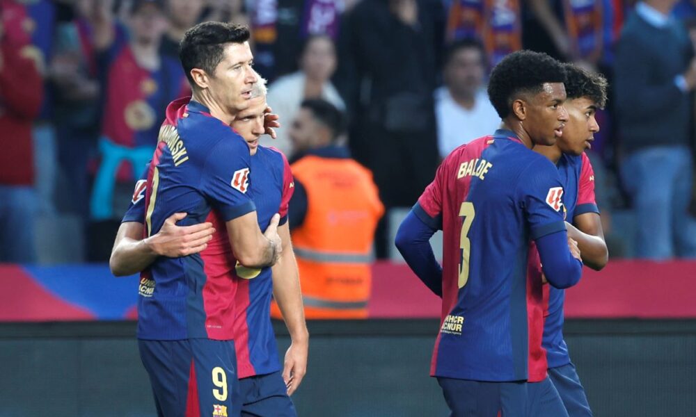 Barcelona's Dani Olmo, second left, celebrates with Barcelona's Robert Lewandowski after scoring his side's opening goal during a Spanish La Liga soccer match between Barcelona and Espanyol at the Lluis Companys Olympic Stadium in Barcelona, Spain, Sunday, Nov. 3, 2024. (AP Photo/Joan Monfort)