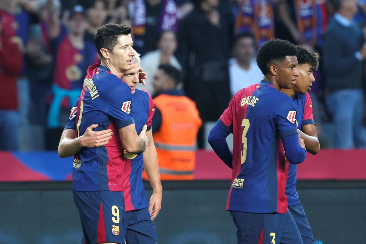 Barcelona's Dani Olmo, second left, celebrates with Barcelona's Robert Lewandowski after scoring his side's opening goal during a Spanish La Liga soccer match between Barcelona and Espanyol at the Lluis Companys Olympic Stadium in Barcelona, Spain, Sunday, Nov. 3, 2024. (AP Photo/Joan Monfort)