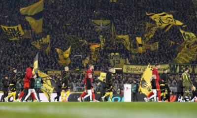 Players enter the pitch for the German Bundesliga soccer match between Borussia Dortmund and Bayern Munich at the Signal-Iduna Park in Dortmund, Germany, Saturday, Nov. 30, 2024. (AP Photo/Martin Meissner)