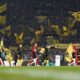 Players enter the pitch for the German Bundesliga soccer match between Borussia Dortmund and Bayern Munich at the Signal-Iduna Park in Dortmund, Germany, Saturday, Nov. 30, 2024. (AP Photo/Martin Meissner)