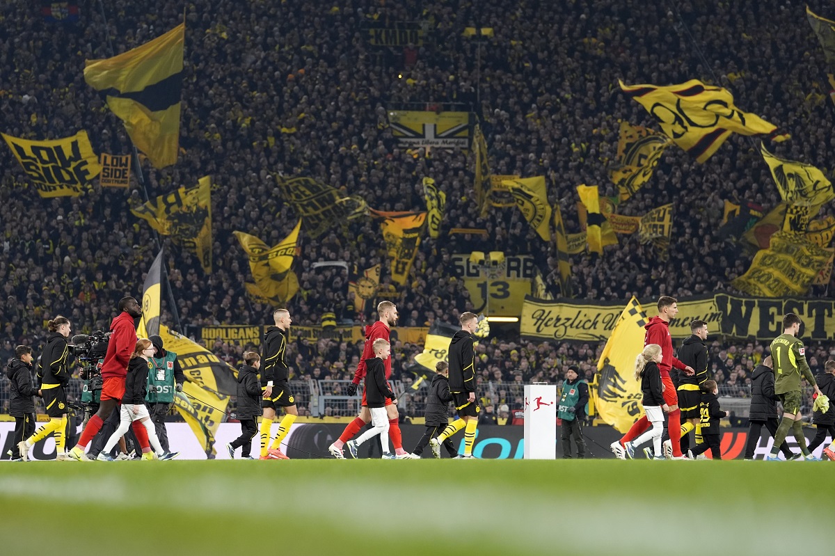 Players enter the pitch for the German Bundesliga soccer match between Borussia Dortmund and Bayern Munich at the Signal-Iduna Park in Dortmund, Germany, Saturday, Nov. 30, 2024. (AP Photo/Martin Meissner)