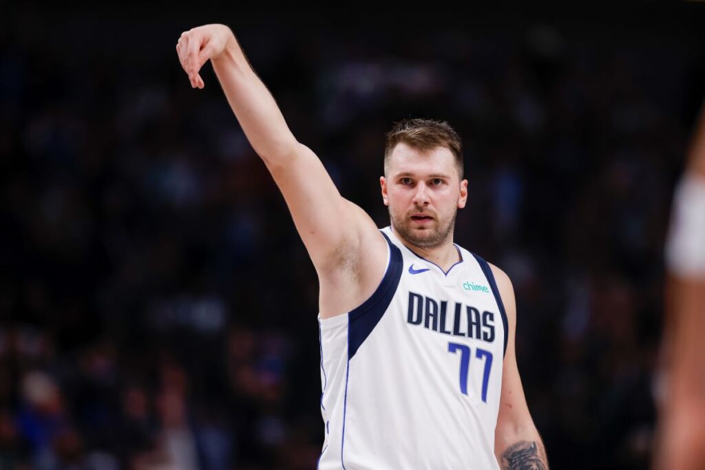 Dallas Mavericks guard Luka Doncic (77) celebrates after a 3-point basket during the first half of an NBA basketball game against the Orlando Magic, Sunday, Nov. 3, 2024, in Dallas. (AP Photo/Gareth Patterson)