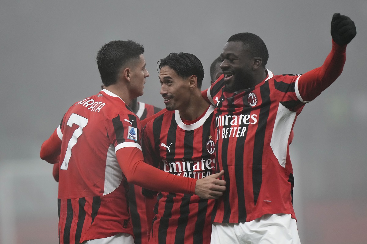 AC Milan's Tijjani Reijnders, center, celebrates with Alvaro Morata, left, and Youssouf Fofana after scoring his side's third goal during the Italian Serie A soccer match between AC Milan and Empoli, at the Milan San Siro stadium, Italy, Saturday, Nov. 30, 2024. (AP Photo/Luca Bruno)