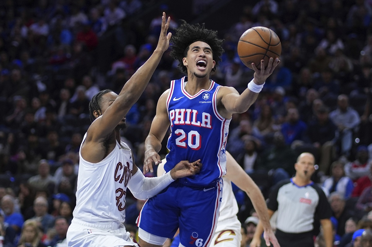 Philadelphia 76ers' Jared McCain, right, goes up for a shot against Cleveland Cavaliers' Isaac Okoro during the first half of an NBA basketball game, Wednesday, Nov. 13, 2024, in Philadelphia. (AP Photo/Matt Slocum)