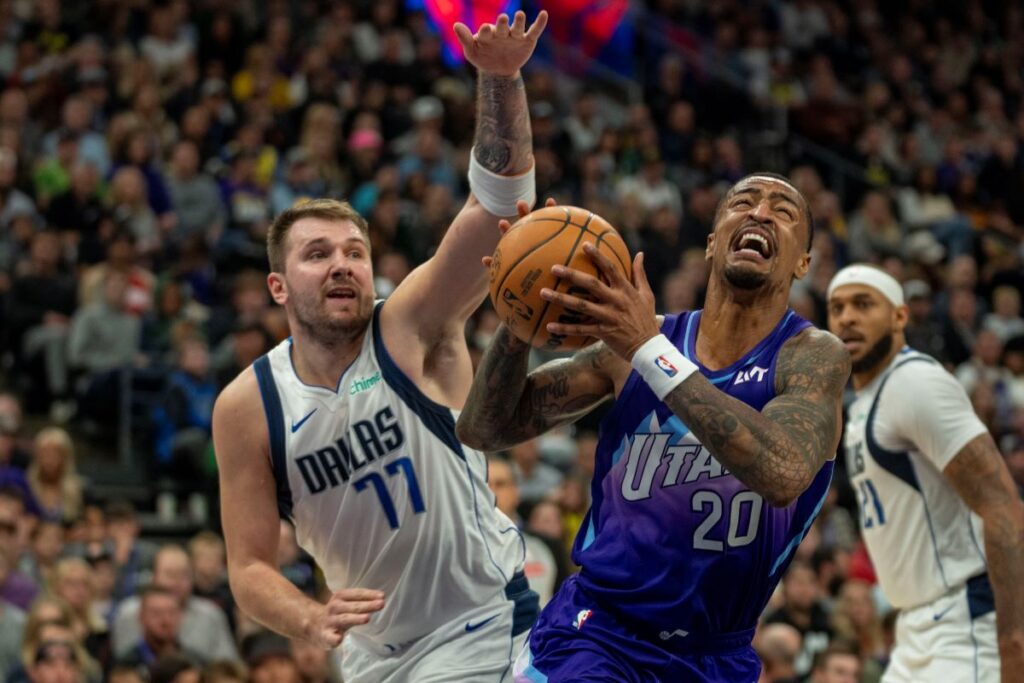 Utah Jazz forward John Collins (20) looks for a shot as Dallas Mavericks guard Luka Doncic (77) defends during the second half of an NBA basketball game Thursday, Nov. 14, 2024, in Salt Lake City. (AP Photo/Rick Egan)