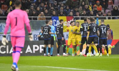 Players scuffle during the UEFA Nations League soccer match between Romania and Kosovo at the National Arena stadium in Bucharest, Romania, Saturday, Nov. 16, 2024. (AP Photo/Alexandru Dobre)