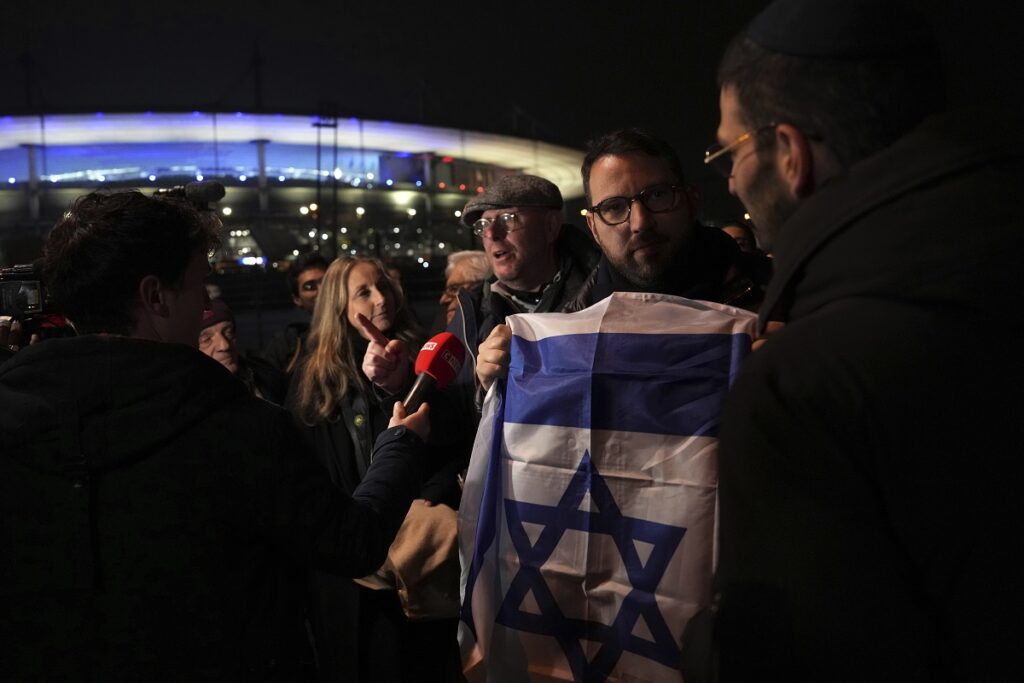 Supporters of Israel answer reporters after the Nations League soccer match France against Israel outside the Stade de France stadium, Thursday, Nov. 14, 2024 in Saint-Denis, outside Paris. (AP Photo/Aurelien Morissard)