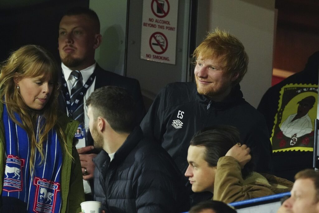 Ipswich Town fan Ed Sheeran, right, looks on during the English Premier League soccer match between Ipswich Town and Manchester United at Portman Road stadium in Ipswich, England, Sunday, Nov. 24, 2024. (AP Photo/Dave Shopland)