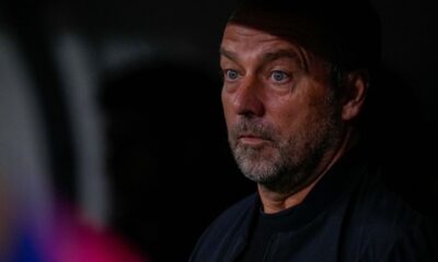 Barcelona's head coach Hansi Flick looks from the bench before a Spanish La Liga soccer match between Real Madrid and Barcelona at the Santiago Bernabeu stadium in Madrid, Spain, Saturday, Oct. 26, 2024. (AP Photo/Manu Fernandez)