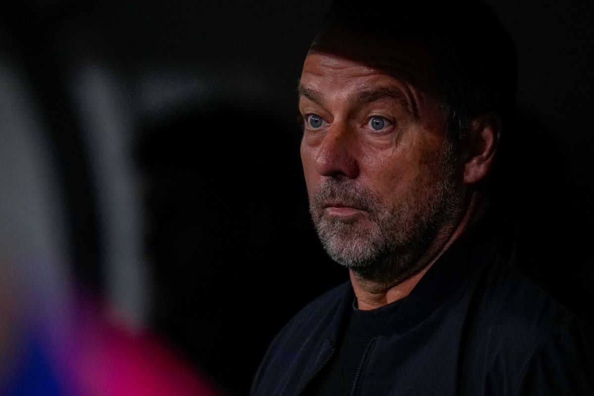 Barcelona's head coach Hansi Flick looks from the bench before a Spanish La Liga soccer match between Real Madrid and Barcelona at the Santiago Bernabeu stadium in Madrid, Spain, Saturday, Oct. 26, 2024. (AP Photo/Manu Fernandez)