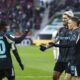 From left, Jeremie Frimpong, Robert Andrich and Florian Wirtz of Bayer Leverkusen celebrate after scoring their side's first goal during the Bundesliga soccer match between FC Augsburg and Bayer Leverkusen at the WWK-Arena in Augsburg, Germany, Saturday, Dec. 14, 2024. (Daniel Löb/dpa via AP)