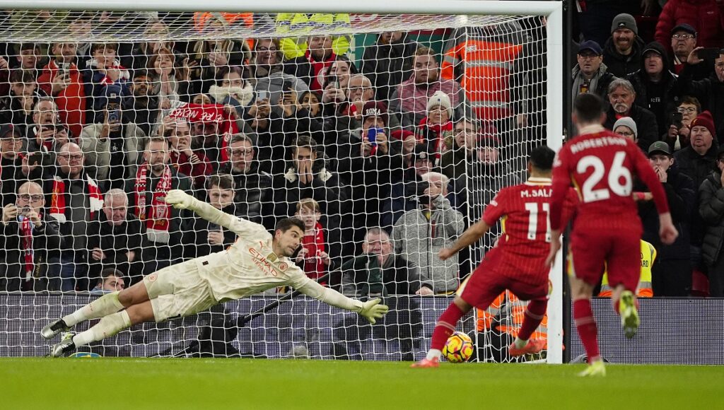 Liverpool's Mohamed Salah scores from the penalty spot past Manchester City goalkeeper Stefan Ortega during an English Premier League soccer match at Anfield Stadium, Liverpool, England, Sunday Dec. 1, 2024. (Peter Byrne/PA via AP)