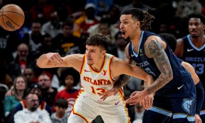 Atlanta Hawks guard Bogdan Bogdanovic (13) loses the ball against Memphis Grizzlies forward Brandon Clarke (15) during the first half of an NBA basketball game, Saturday, Dec. 21, 2024, in Atlanta. (AP Photo/Mike Stewart