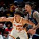 Atlanta Hawks guard Bogdan Bogdanovic (13) loses the ball against Memphis Grizzlies forward Brandon Clarke (15) during the first half of an NBA basketball game, Saturday, Dec. 21, 2024, in Atlanta. (AP Photo/Mike Stewart