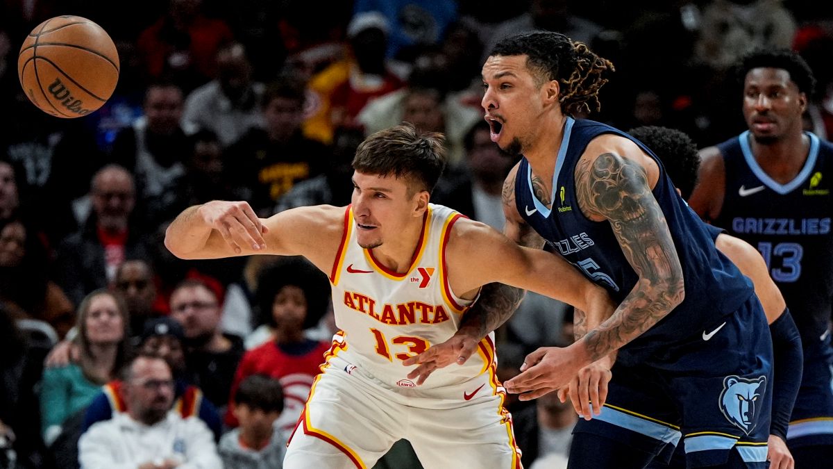 Atlanta Hawks guard Bogdan Bogdanovic (13) loses the ball against Memphis Grizzlies forward Brandon Clarke (15) during the first half of an NBA basketball game, Saturday, Dec. 21, 2024, in Atlanta. (AP Photo/Mike Stewart