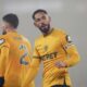 Wolverhampton Wanderers' Matheus Cunha celebrates his sides second goal scored by Hwang Hee-Chan during the English Premier League soccer match between Wolverhampton Wanderers and Manchester United at the Molineux Stadium, Wolverhampton, England, Thursday, Dec. 26, 2024. (David Davies/PA via AP)