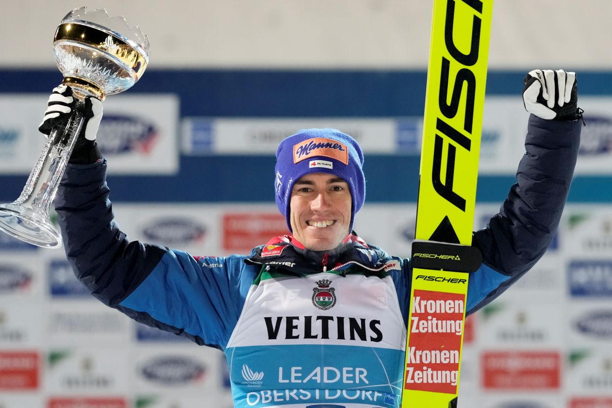 Stefan Kraft, of Austria, poses with his trophy after winning the first stage of the 73rd Four Hills ski jumping tournament in Oberstdorf, Germany, Sunday, Dec. 29, 2024. (AP Photo/Matthias Schrader)