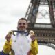 FILE -Remco Evenepoel, of Belgium, shows his gold medals of the men's time trial and road cycling events, at the 2024 Summer Olympics, Saturday, Aug. 3, 2024, in Paris, France. (AP Photo/Thibault Camus, File)