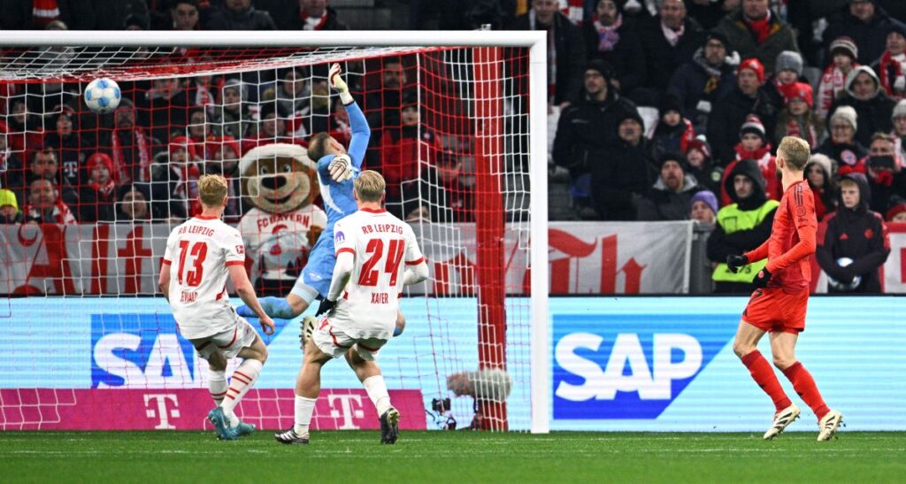 Munich's Konrad Laimer, right, scores during the Bundesliga soccer match between Bayern Munich and RB Leipzig at the Allianz Arena, Munich, Germany, Friday Dec. 20, 2024. (Tom Weller/dpa via AP)