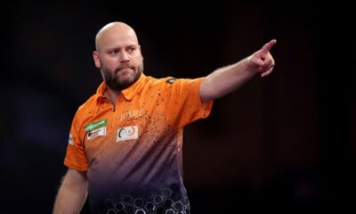 Christian Kist celebrates during his first round match against Madars Razma on day four of the Paddy Power World Darts Championship at Alexandra Palace in London, Wednesday, Dec. 18, 2024. (Bradley Collyer/PA via AP)