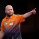 Christian Kist celebrates during his first round match against Madars Razma on day four of the Paddy Power World Darts Championship at Alexandra Palace in London, Wednesday, Dec. 18, 2024. (Bradley Collyer/PA via AP)