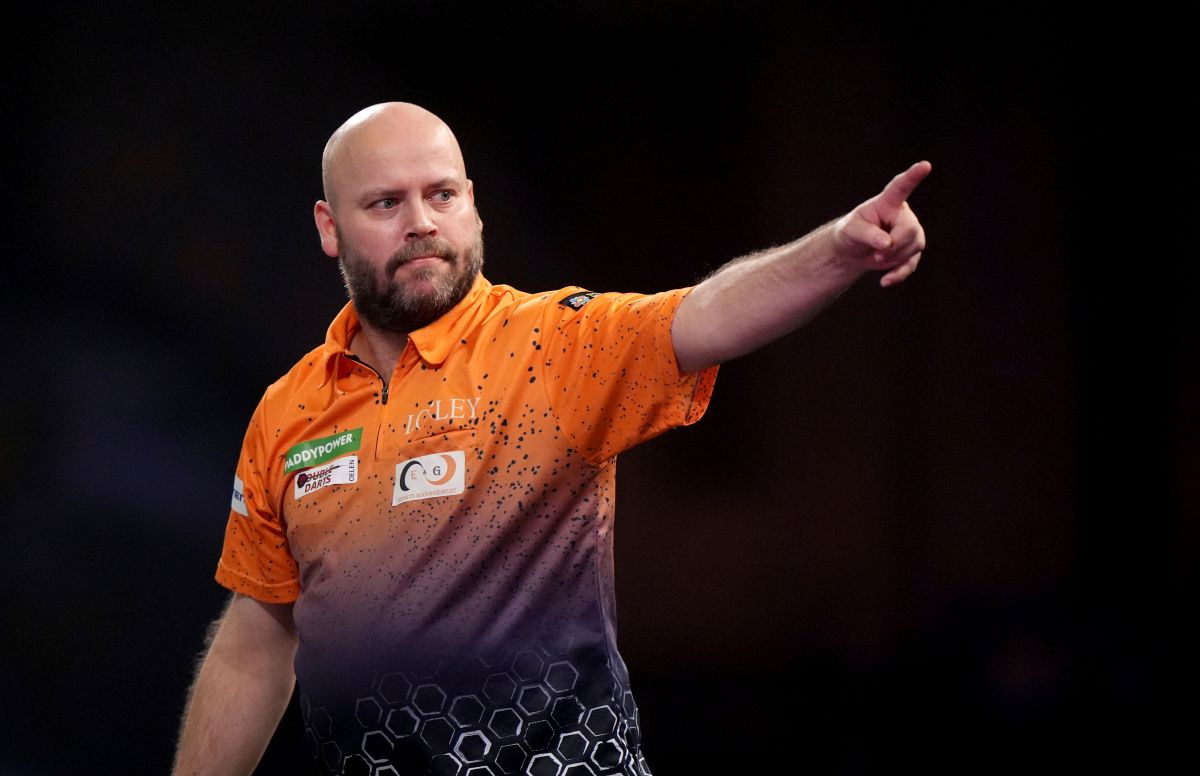 Christian Kist celebrates during his first round match against Madars Razma on day four of the Paddy Power World Darts Championship at Alexandra Palace in London, Wednesday, Dec. 18, 2024. (Bradley Collyer/PA via AP)