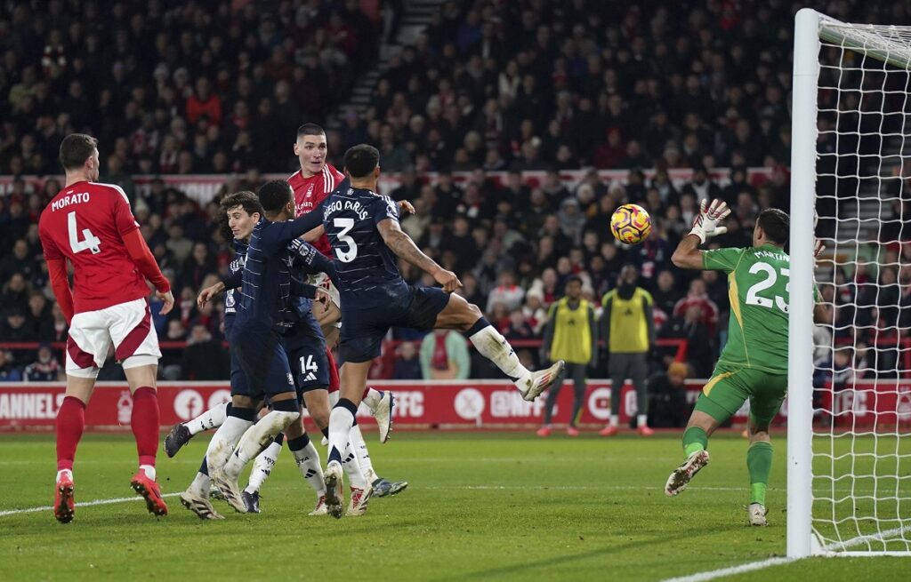 Nottingham Forest's Nikola Milenkovic scores his side's first goal of the game, during the English Premier League soccer match between Nottingham Forest and Aston Villa,  at the City Ground, in Nottingham, England, Saturday, Dec. 14, 2024. (Joe Giddens/PA via AP)