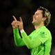 Wolfsburg's Jonas Wind celebrates scoring his side's second goal during a Bundesliga soccer match between Wolfsburg and Hoffenheim, at the Volkswagen Arena in Wolfsburg, Germany, Wednesday, Dec. 4, 2024. (Swen Pförtner/dpa via AP)