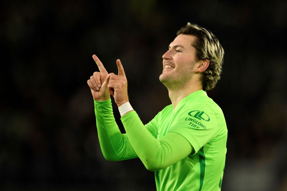 Wolfsburg's Jonas Wind celebrates scoring his side's second goal during a Bundesliga soccer match between Wolfsburg and Hoffenheim, at the Volkswagen Arena in Wolfsburg, Germany, Wednesday, Dec. 4, 2024. (Swen Pförtner/dpa via AP)