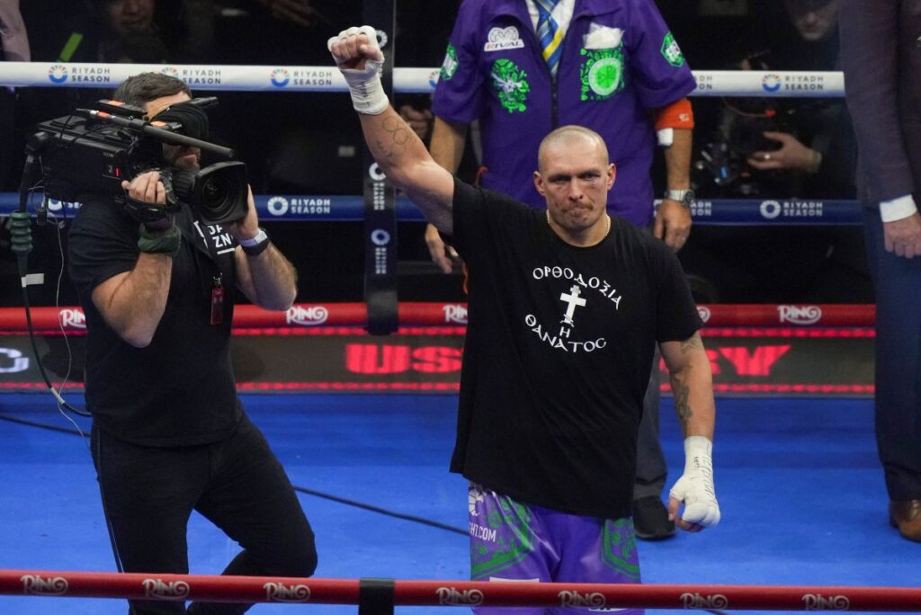 Ukraine's Oleksandr Usyk celebrates after winning the WBA, WBO, and WBC world heavyweight title fight against Britain's Tyson Fury in Riyadh, Saudi Arabia, Sunday, Dec. 22, 2024. (AP Photo/Frank Augstein)