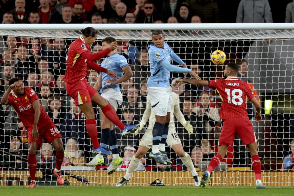 Liverpool's Virgil van Dijk, 2nd left, jumps to head the ball during the English Premier League soccer match between Liverpool and Manchester City at Anfield Stadium, Liverpool, England, Sunday Dec. 1, 2024. (AP Photo/Ian Hodgson)