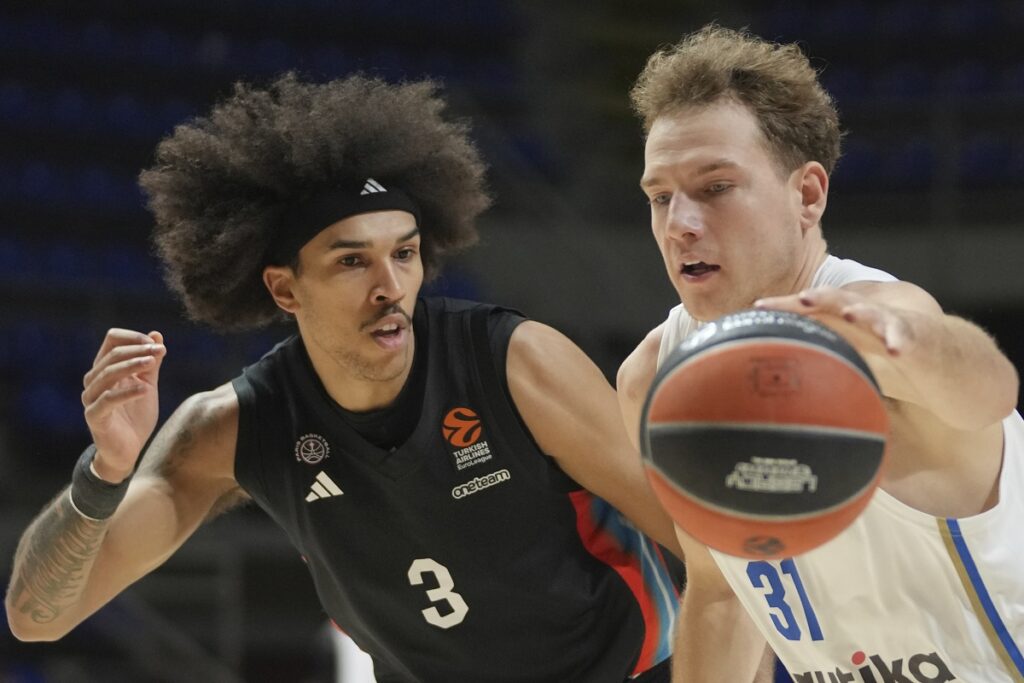 Maccabi's Rokas Jokubaitis, right, drives to the basket as Paris Basketball's Tyson Ward tries to block him during the Euroleague basketball match between Maccabi Tel Aviv and Paris Basketball in Belgrade, Serbia, Tuesday, Dec. 3, 2024. (AP Photo/Darko Vojinovic)