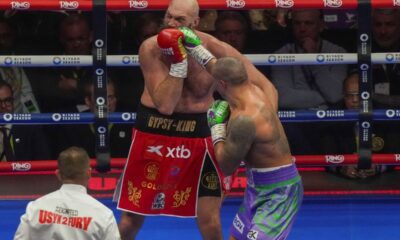 Boxers Britain's Tyson Fury, left, and Ukraine's Oleksandr Usyk compete during their WBA, WBO, and WBC world heavyweight title fight in Riyadh, Saudi Arabia, Saturday, Dec. 21, 2024. (AP Photo/Frank Augstein)