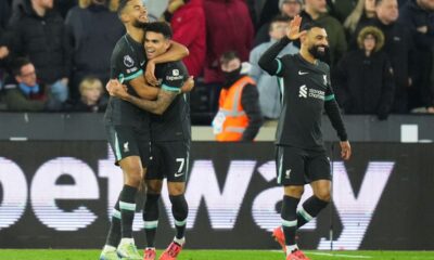 Liverpool's Cody Gakpo, left, celebrates with teammates after scoring his side's second goal during the English Premier League soccer match between West Ham United and Liverpool at the London Stadium in London, Sunday, Dec. 29, 2024. (AP Photo/Kirsty Wigglesworth)