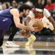 Charlotte Hornets guard Vasilije Micic, left, and Washington Wizards guard Bilal Coulibaly, right, battle for the ball during the first half of an NBA basketball game, Thursday, Dec. 19, 2024, in Washington. (AP Photo/Nick Wass)