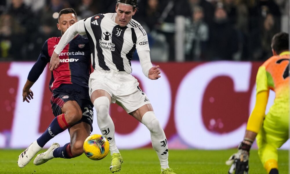 Juventus' Dusan Vlahovic, right, and Cagliari's Mateusz Wieteska, left, challenge for the ball during the round of sixteen Coppa Italia soccer match between Juventus Turin and Cagliari Calcio in Turin, Italy, Tuesday, Dec. 17, 2024. (Fabio Ferrari/LaPresse via AP)