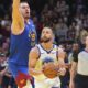 Golden State Warriors guard Stephen Curry, right, drives past Denver Nuggets center Nikola Jokic to put up a last-second, 3-point shot in the second half of an Emirates NBA Cup basketball game Tuesday, Dec. 3, 2024, in Denver. (AP Photo/David Zalubowski)