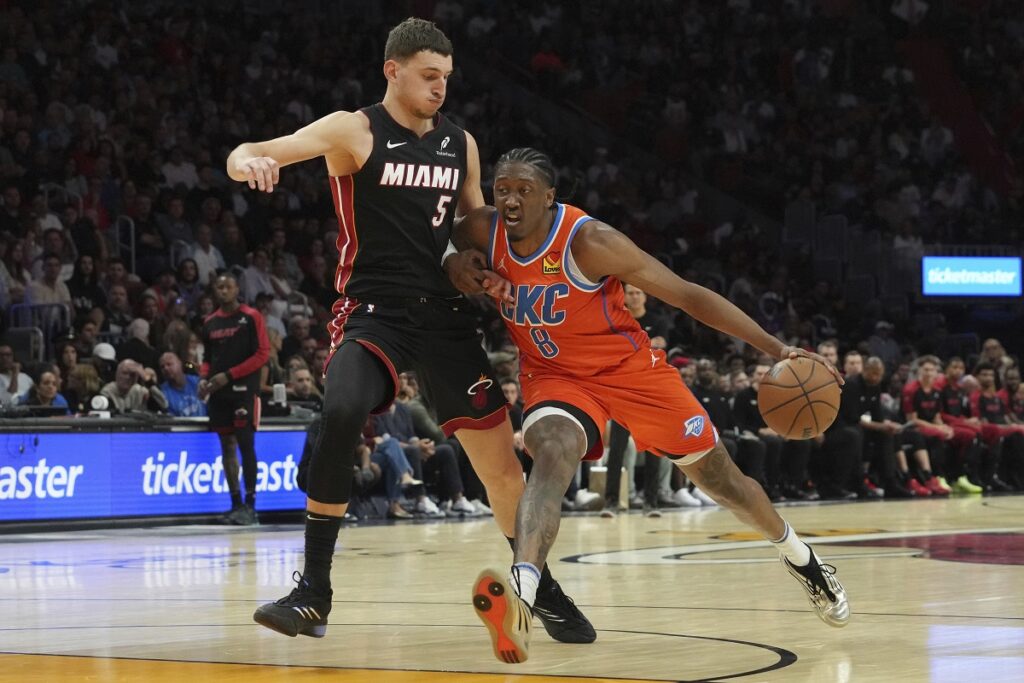 Miami Heat forward Nikola Jovic (5) defends Oklahoma City Thunder forward Jalen Williams (8) during the first half of an NBA basketball game, Friday, Dec. 20, 2024, in Miami. (AP Photo/Marta Lavandier)