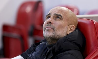 Manchester City's head coach Pep Guardiola sits on the bench before the English Premier League soccer match between Liverpool and Manchester City at Anfield Stadium, Liverpool, England, Sunday Dec. 1, 2024. (AP Photo/Ian Hodgson)