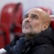 Manchester City's head coach Pep Guardiola sits on the bench before the English Premier League soccer match between Liverpool and Manchester City at Anfield Stadium, Liverpool, England, Sunday Dec. 1, 2024. (AP Photo/Ian Hodgson)