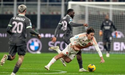 AC Milan's Youssouf Fofana, center left, and Roma's Paulo Dybala fights for the ball during the Serie A soccer match between AC Milan and Roma at the San Siro stadium, in Milan, Italy, Sunday, Dec. 29, 2024. (AP Photo/Antonio Calanni)