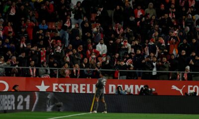 Real Madrid's Jude Bellingham celebrates in front of Girona supporters after scoring the opening goal during a Spanish La Liga soccer match between Girona and Real Madrid at the Montilivi stadium in Girona, Spain, Saturday, Dec. 7, 2024. (AP Photo/Joan Monfort)